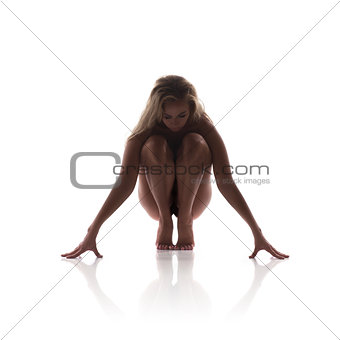 Sexy naked blond woman sitting isolated