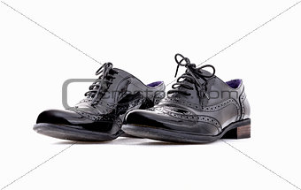 Footwear Concept. Horizontal Image. Pair of black female classic leather shoes isolated on the white background
