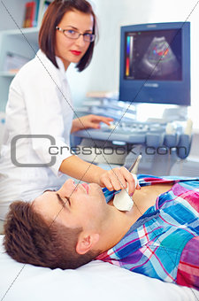 ultrasound scanning of a thyroid of man