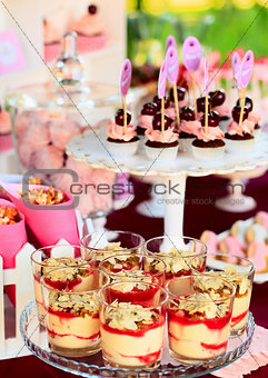 Sweet holiday buffet with cupcakes and tiramisu glasses