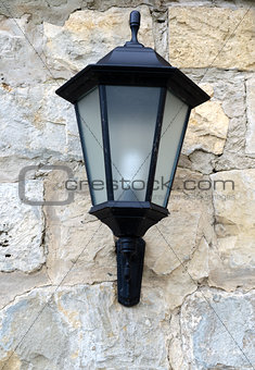 Classic lantern on stone wall