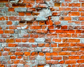 Brick damaged wall with cracks as background