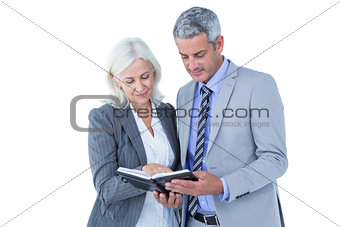 Smiling businesswoman and man with a notebook