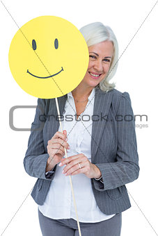 Businesswoman holding happy smiley face