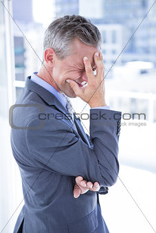 Troubled businessman holding his head