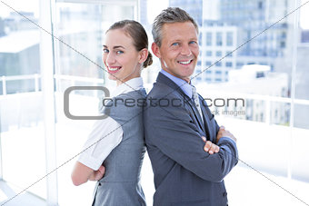Two business colleagues standing back to back