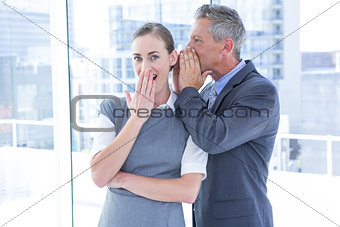Secretive business colleagues whispering