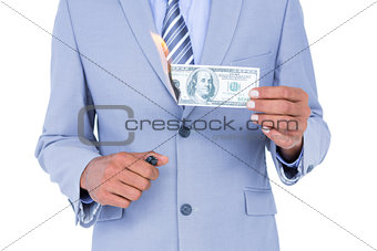 businessman burning a dollar banknote