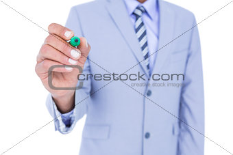 Businessman writing with black marker