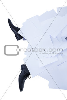 businessman burried under piece of paper