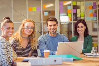 Group of young colleagues using laptop