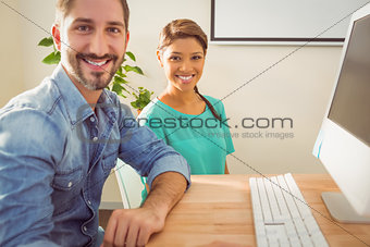 Portrait of two colleague using a computer