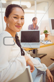 Smiling young businesswoman looking at the camera