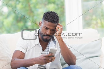 Worried man looking at his phone