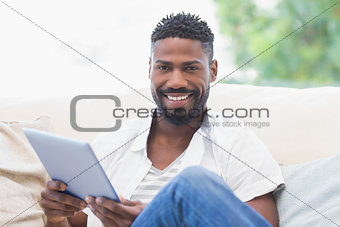 Man using his tablet on couch