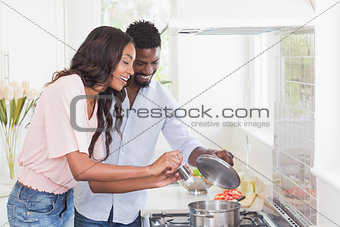 Happy couple cooking food together