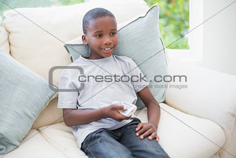 Little boy watching tv on the couch