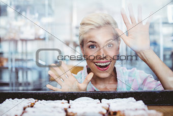 Astonished pretty woman looking at cup cakes