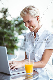 Happy pretty woman using her laptop computer