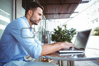 Attentive businessman using his laptop