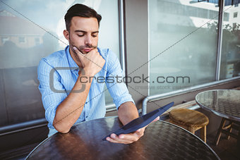 Attentive businessman using a tablet