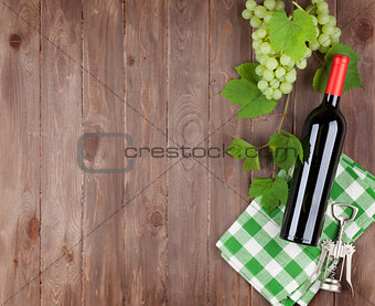 Bunch of grapes, red wine bottle