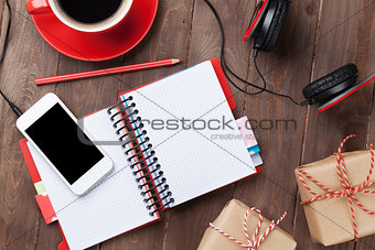Desk with notepad, smartphone and gift boxes