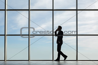 Stylish business man in the background of a large window