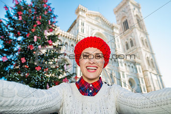 Woman tourist taking selfie in Ñhristmas decorated Florence