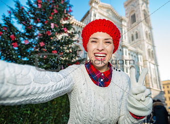 Woman tourist making selfie in Christmas decorated Florence