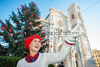 Traveler pointing on something near christmas tree in Florence