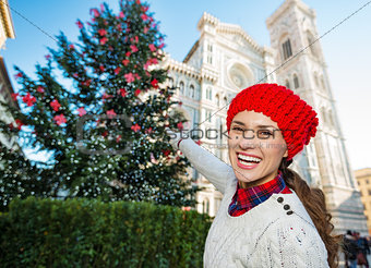 Woman tourist pointing on traditional christmas tree in Florence