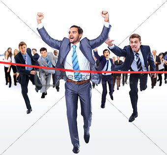 Happy businessman running through finishing line