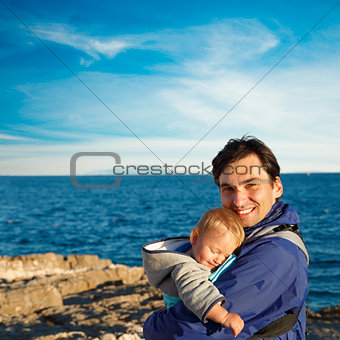 Happy Father with His Little Son in Carrier