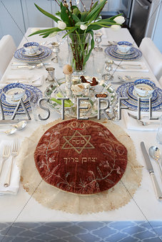 Fully set passover seder table setting.