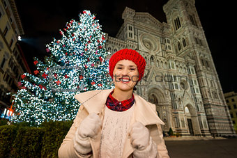 Happy woman standing near Christmas tree in Florence, Italy