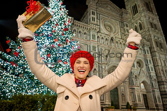Happy woman rejoicing near Christmas tree in Florence, Italy