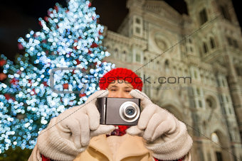 Close up on camera in hands of woman in Christmas Florence