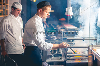 male cooks preparing meal