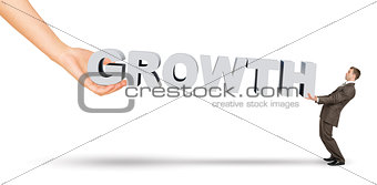 Businessman and hand holding word growth