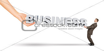 Businessman and hand holding word business