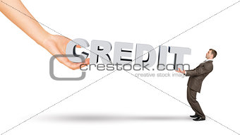 Businessman and hand holding word credit