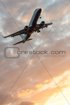 Airplane Flying at Sunset or Sunrise