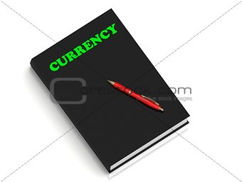 CURRENCY- inscription of green letters on black book 