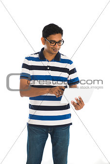Happy young man using digital tablet against white background.