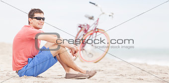 man biking at the beach