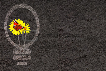 Eco background with soil and light bulb silhouette 