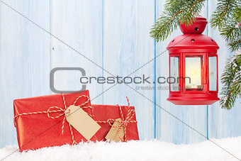 Christmas candle lantern, gift boxes and fir tree
