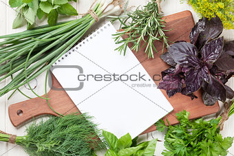 Fresh garden herbs and notepad