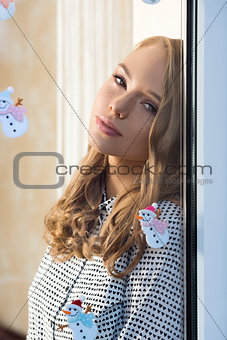 relaxed girl at window in xmas time 